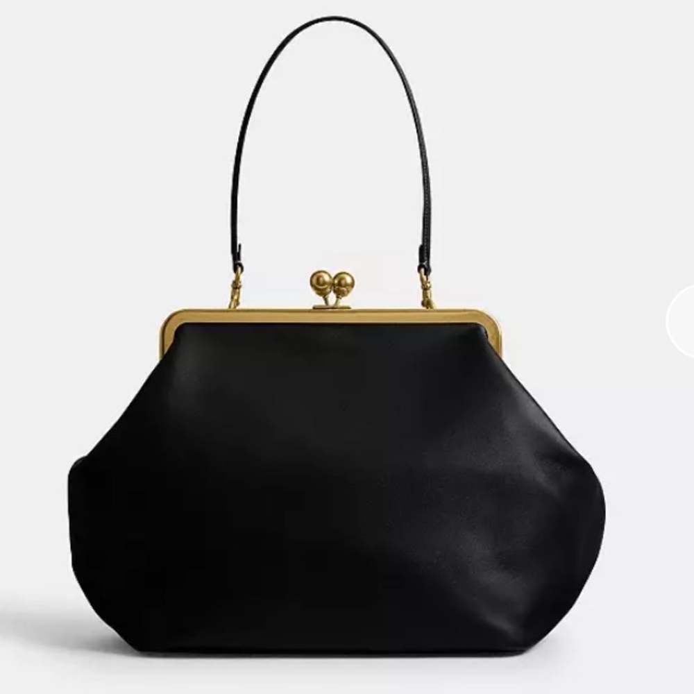 SOLD! Coach Black Kisslock Frame Bag
Best price on PM